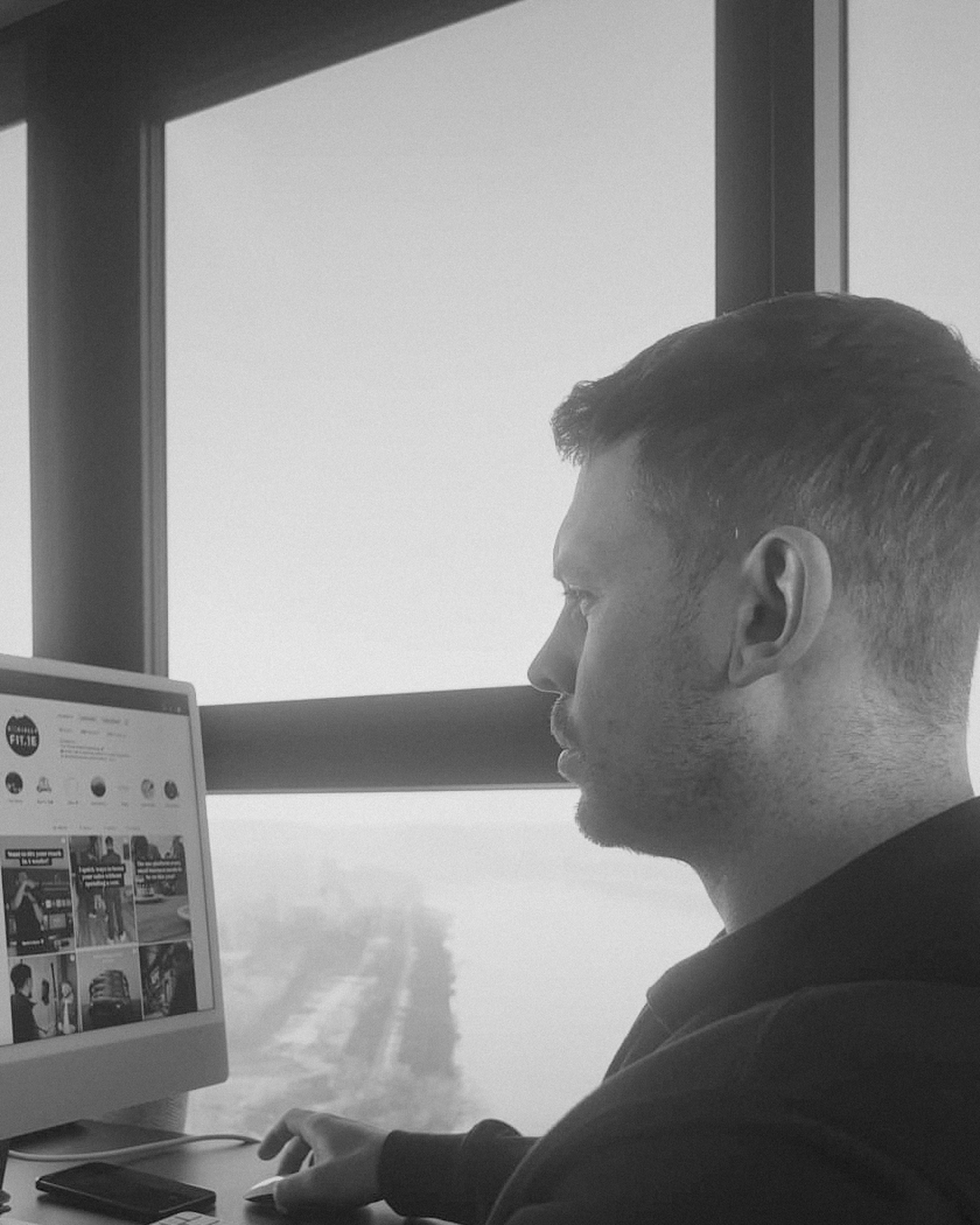 Daire Curley working at his desk